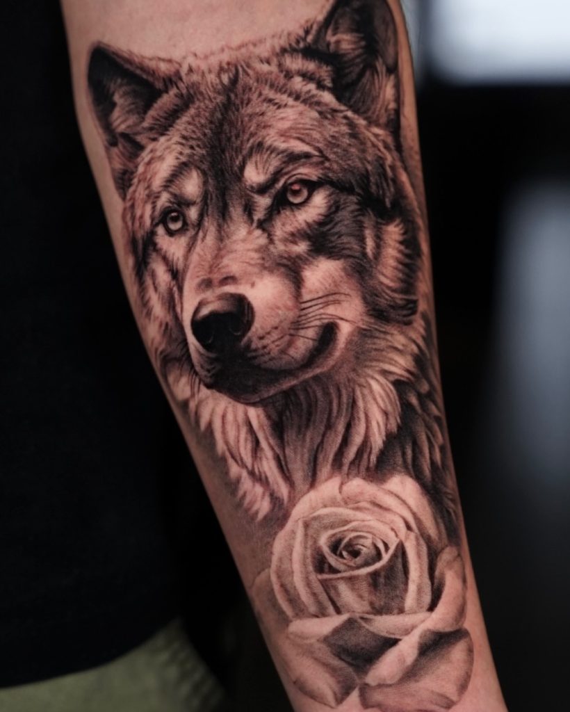 Realistic wolf tattoo on arm