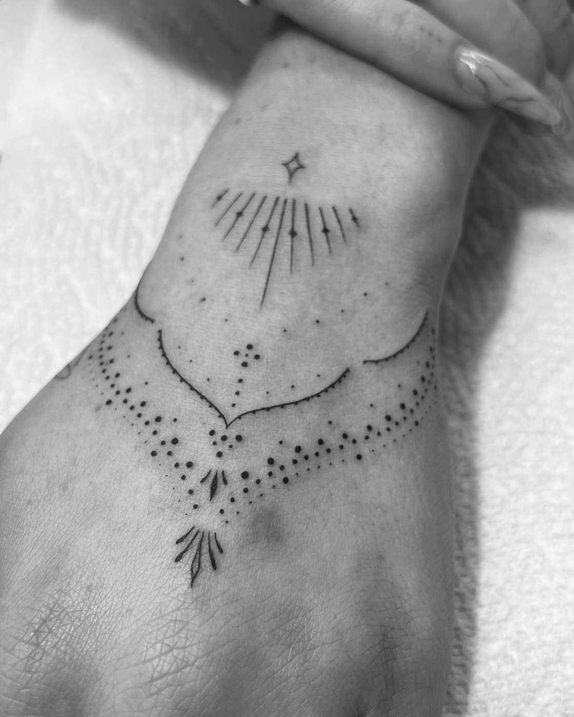 Walk in tattoo Markham clients choose: a fine line geometric wrist piece done at The KCHN Tattoos