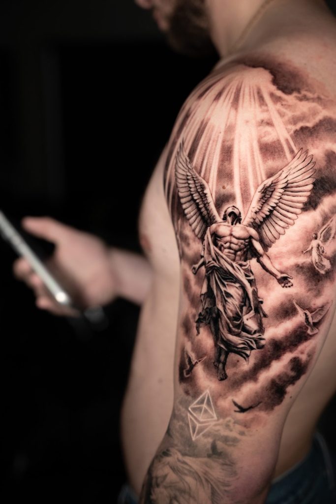 Black and grey realism angel ribs tattoo by The KCHN Tattoos, Scarborough