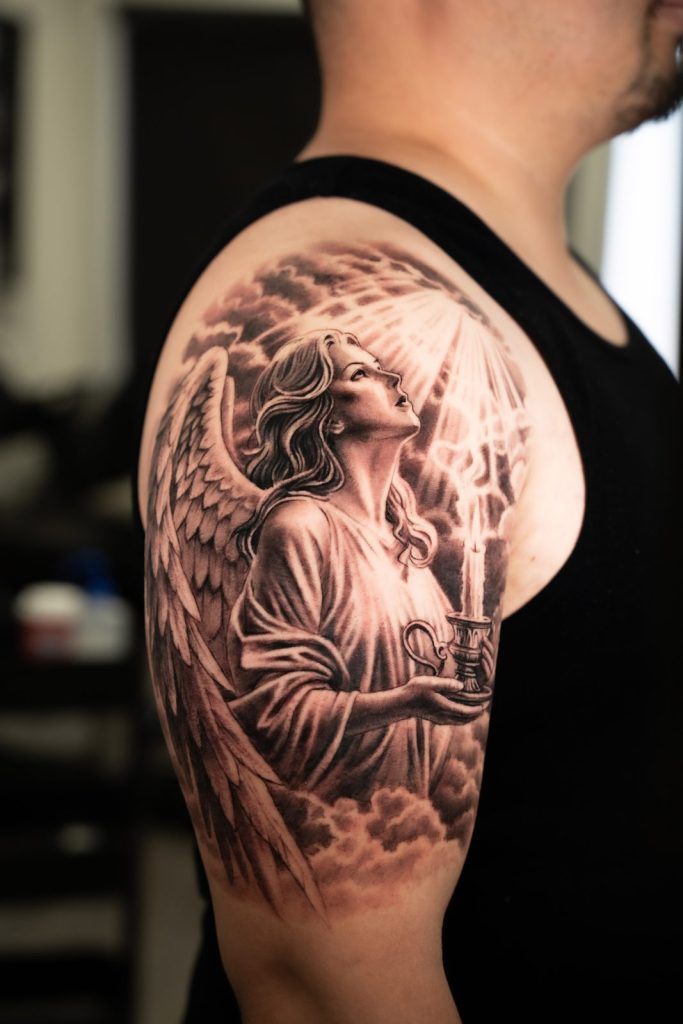 Black and grey realism angel shoulder tattoo by The KCHN Tattoos, Scarborough