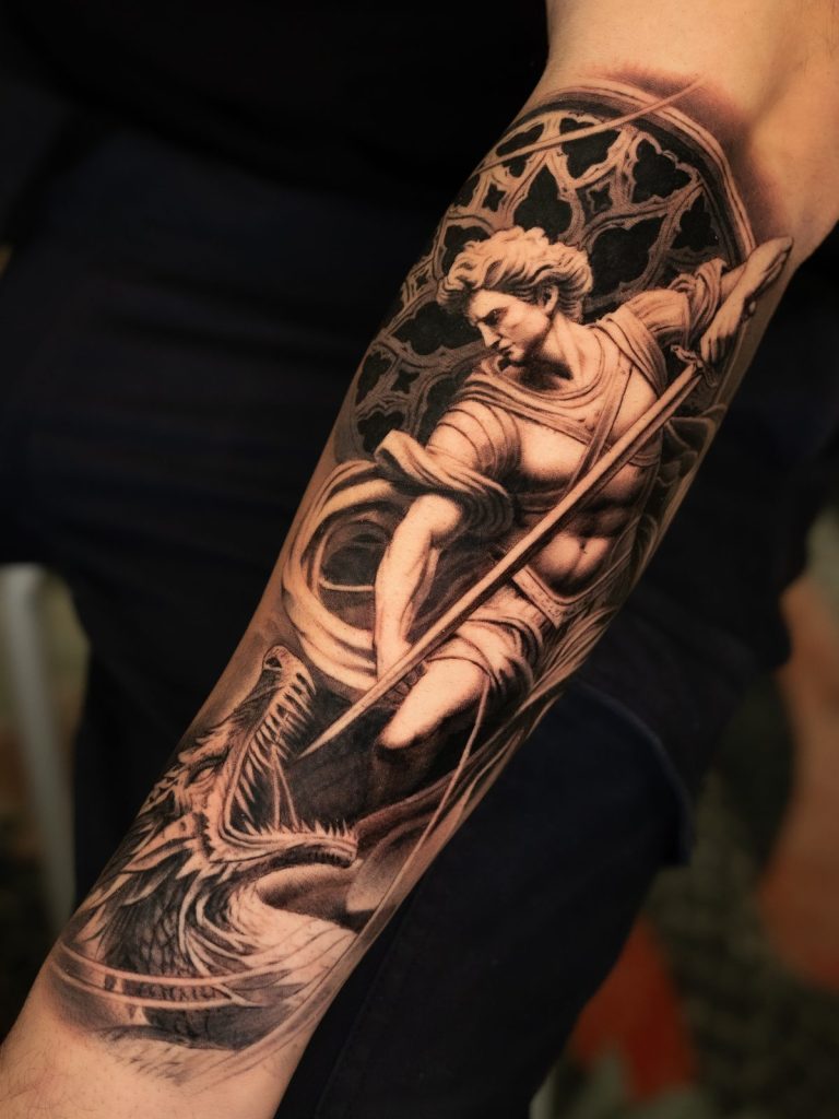 Black and grey realism cherub forearm tattoo by The KCHN Tattoos, Scarborough