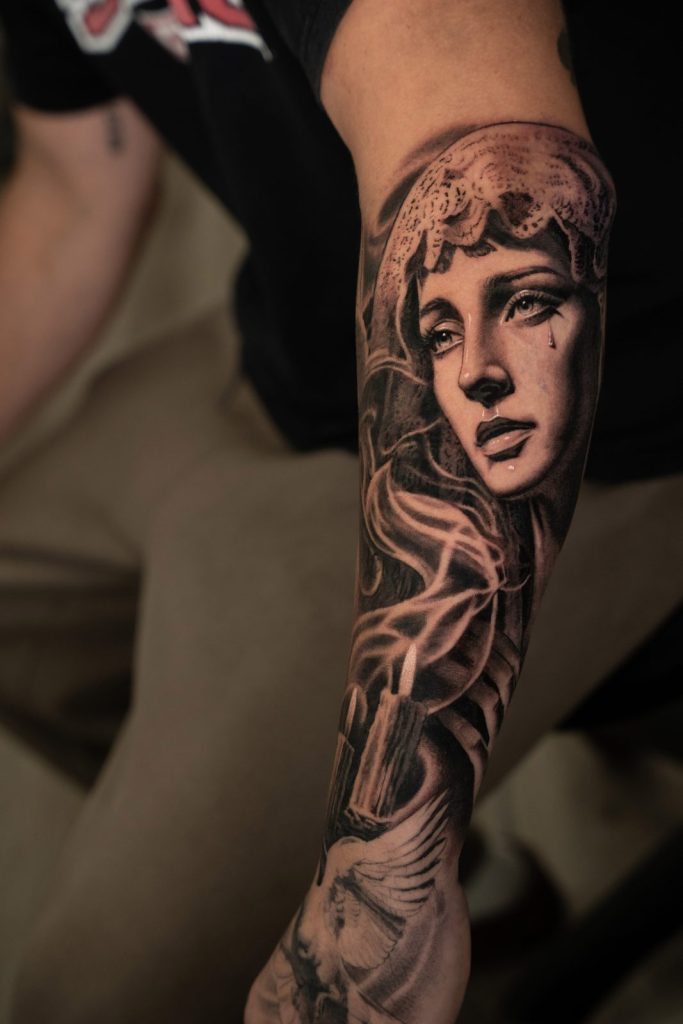 Black and grey realism woman portrait sleeve tattoo by The KCHN Tattoos, Scarborough